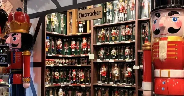 Christmas nutcracker display in German-style shop decorated with festive garland & lights