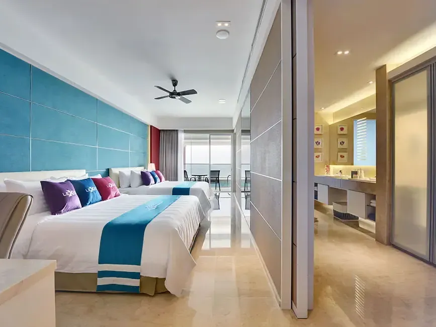 Spacious premium pool suite with two large beds and open concept bathroom – Lexis Suites Penang