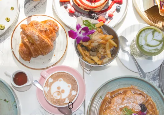     Brunch spread with waffles, croissant, coffee and matcha at Sunny Side Cafe in Miami’s MiMo District