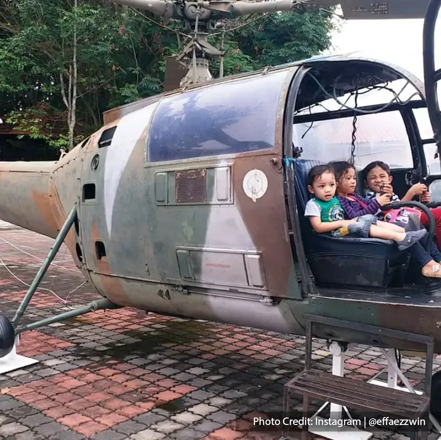 Photograph of tourists in old war helicopter