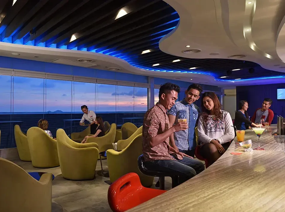 Guests enjoying cocktails and sunset view at Satellite Bar View.