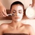 Face mask applied by a brush to a guest on a table at Oregon Garden Resort, a top choice hotel in Silverton