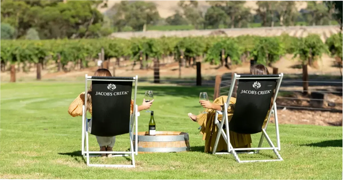 Two people sit in the vineyards at Jacob’s Creek winery.