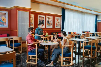 Family enjoying meal at Coralz Bistro - Lexis Hotels & Resorts