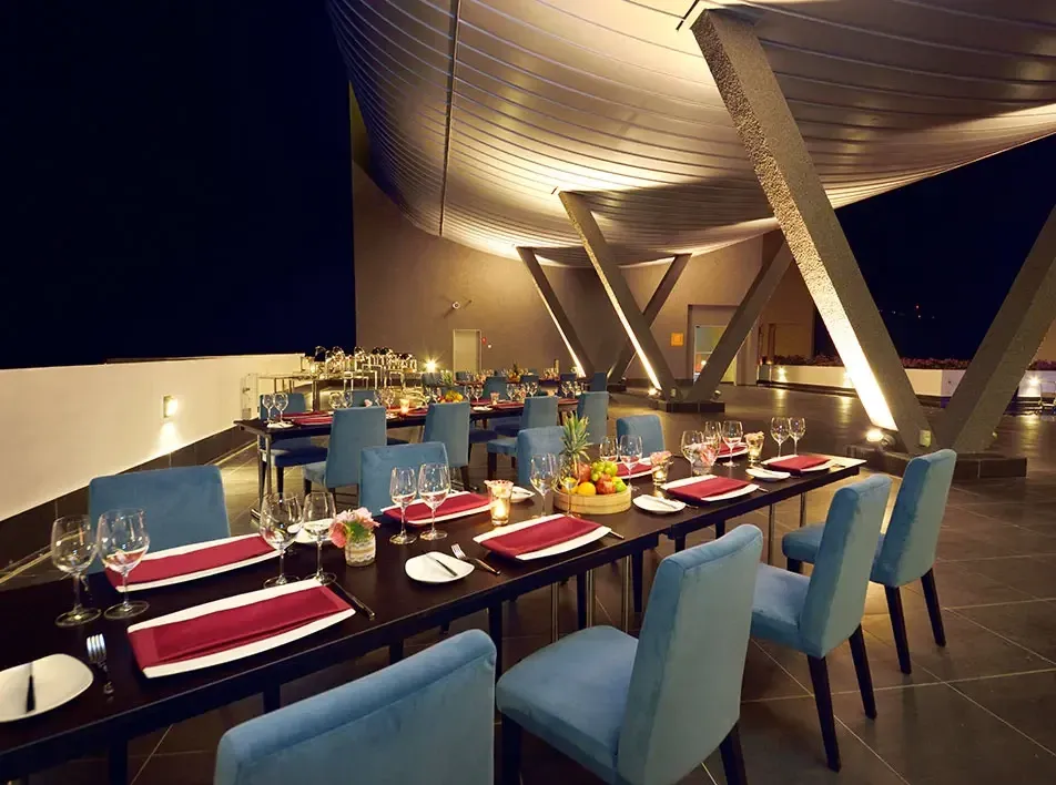 Outdoor dinner area with blue chairs at Sky Terrace Restaurant Dining Area.