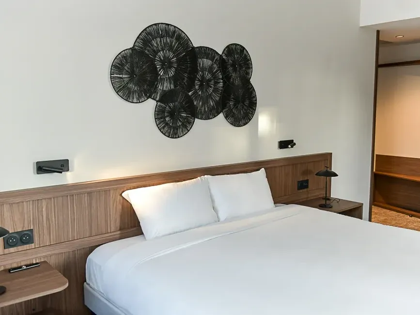 Chambre confort élégante avec lit double et décoration murale unique à l'Hôtel Rivella à Clisson.