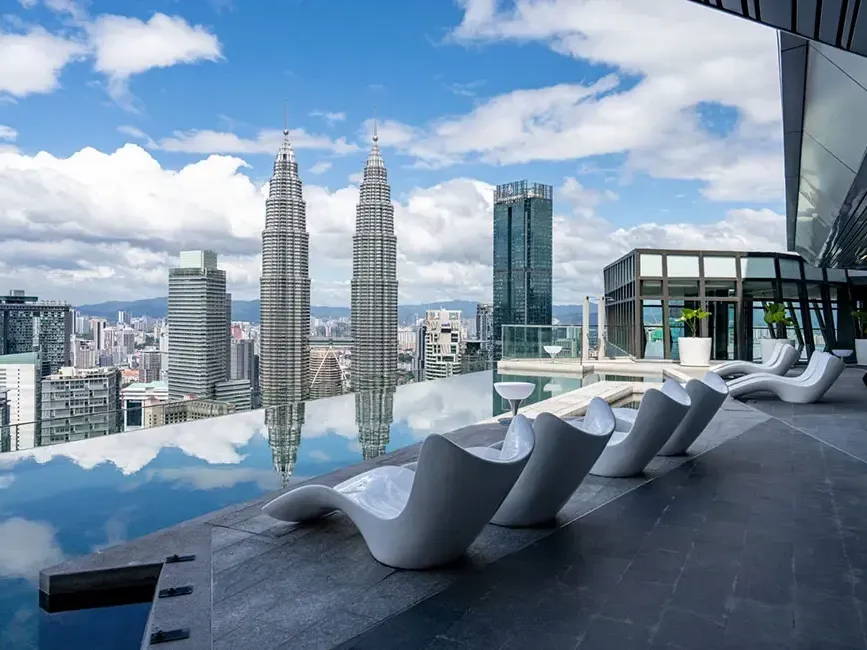 The stunning rooftop infinity pool at Imperial Lexis KL with an unobstructed Twin Tower view.