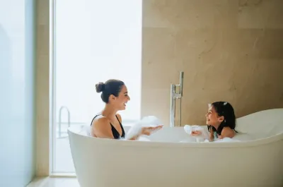 Mother and daughter enjoying a bubble bath - Lexis Hotels & Resorts