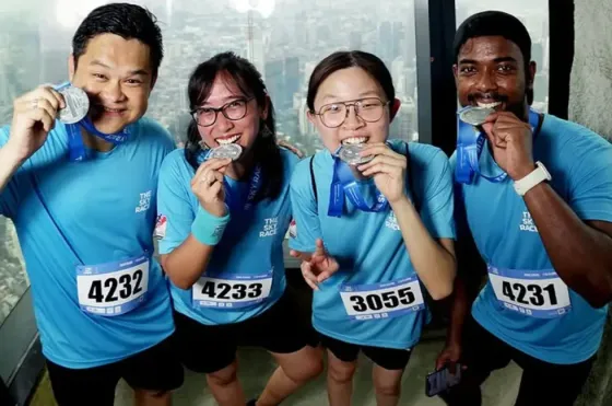 Four participants at Sky Race posing with their medals at Merdeka 118 - Imperial Lexis Kuala Lumpur