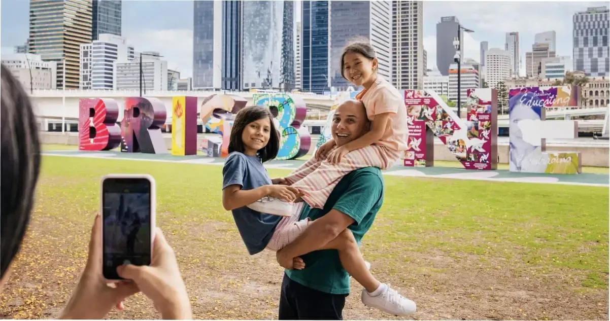 A family posing for a photo at South Bank, Brisbane