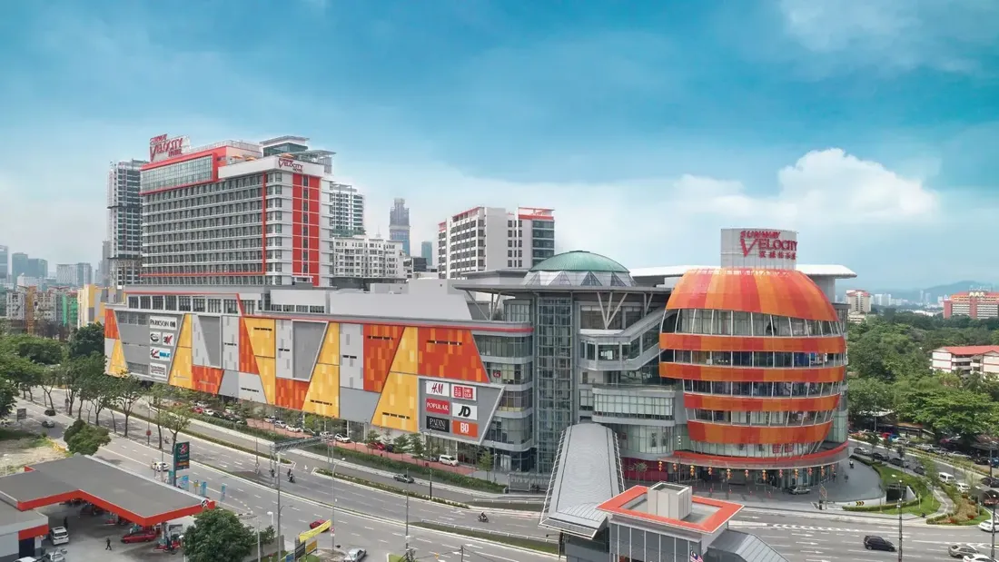 Sunway Velocity Hotel and Mall, with a colorful facade and the city skyline in the background