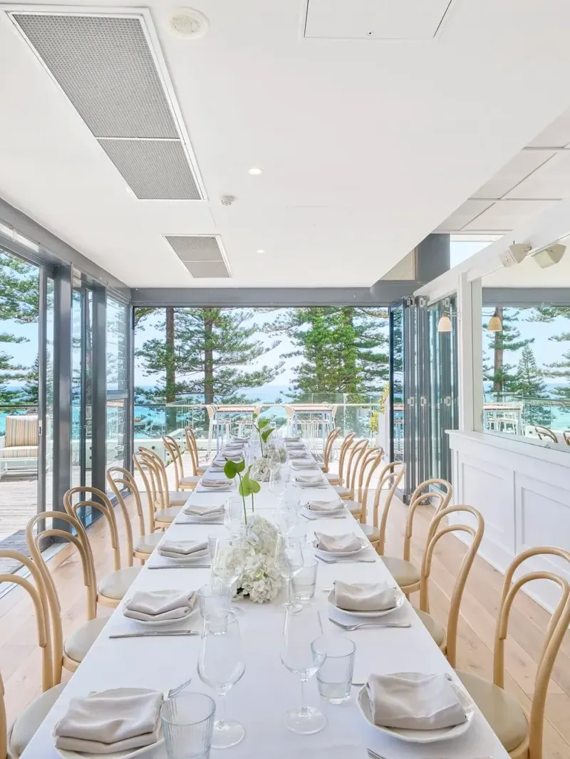 Long white dining table at Elysium Manly under a vaulted ceiling floor in Cibaria\'s Terrazza, perfect for Manly event venues