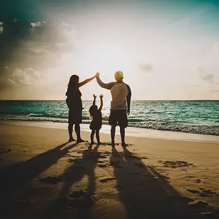 A family having fun on a sunny beach during the school holidays - Lexis MY