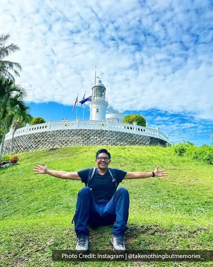 A man was taking a picture with Cape Rachado Lighthouse - Grand Lexis Port Dickson