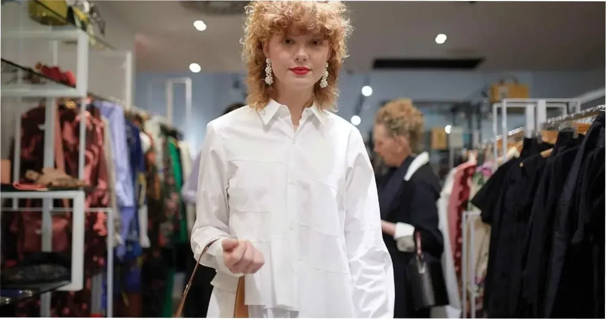 A woman trying on an outfit at Camargue on James Street, Brisbane.