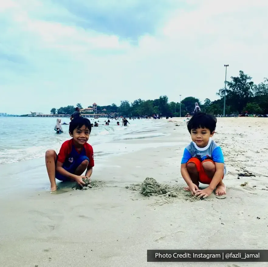 tourists having fun with their beach activities in Saujana Beach Port Dickson