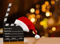 Festive movie clapperboard wearing a Santa hat in Community Movie Lounge at Spring Creek Resorts