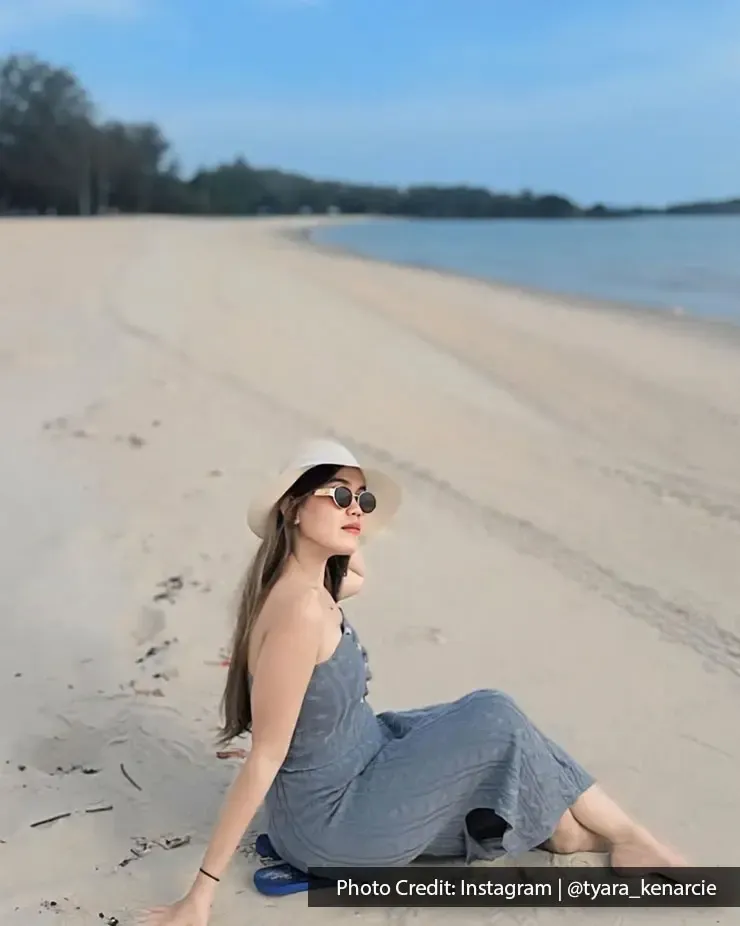 A lady sitting on the beach, posing for an image during her beach trip - Lexis MY