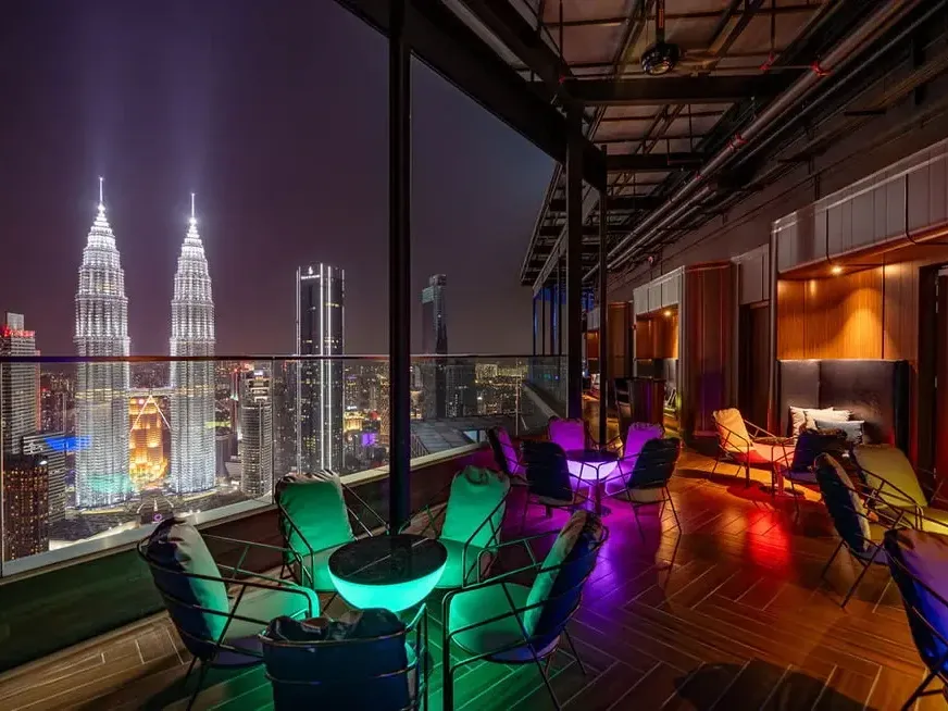 Luxury rooftop bar at Imperial Lexis KL featuring a private pool suite vibe and Twin Tower view at night.