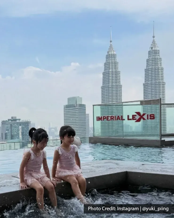 Children sitting beside the infinity pool at Imperial Lexis Kuala Lumpur