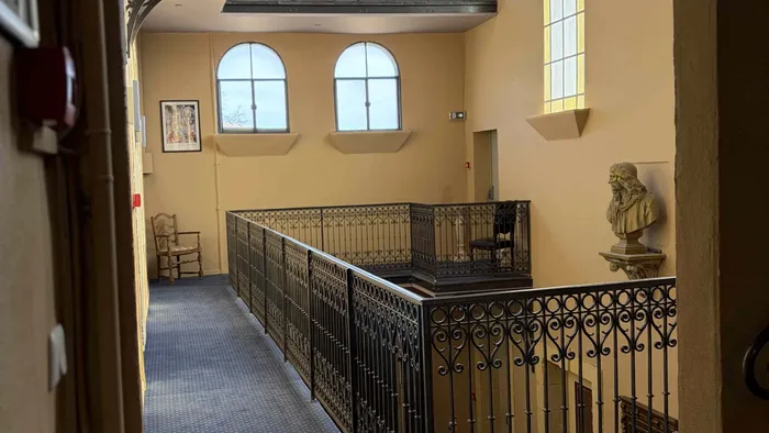 Couloir avec balustrade en fer et buste antique au Grand Hôtel Molière