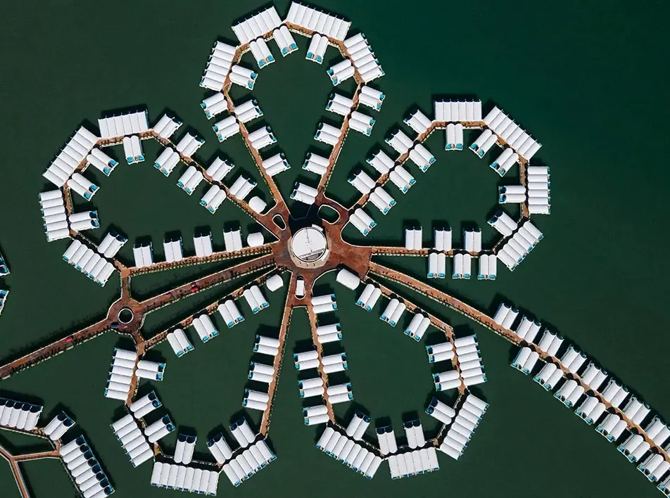 Top-down aerial view of Lexis Hibiscus overwater villas in a hibiscus flower shape.