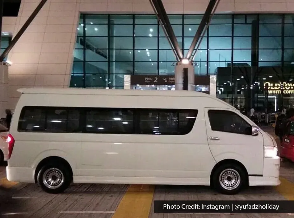 Public transport van waiting at Penang International Airport arrival area at night