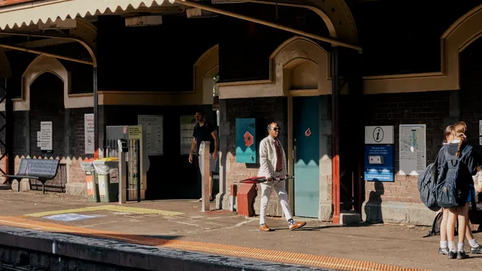 People at train station platform with public transport.
