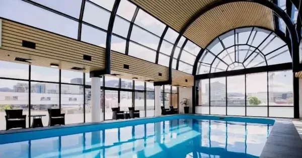 swimming pool with floor to ceiling arched windows