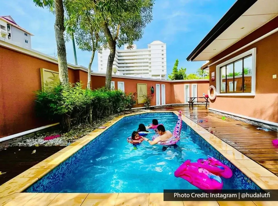 Children enjoying a private swimming pool with inflatable floats at a resort villa.
