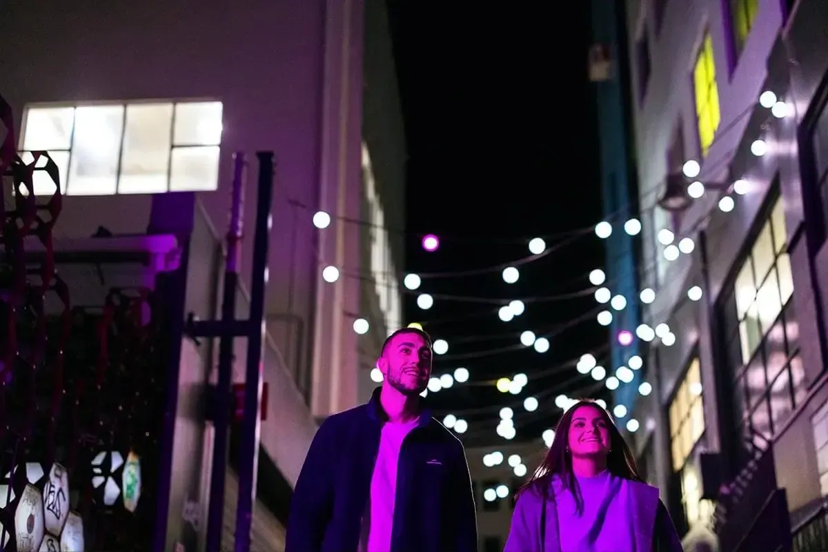 Couple enjoy evening walk along Cuba Street, Wellington
