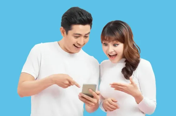 Couple engaged in conversation while making payment online - Lexis Hotels & Resorts