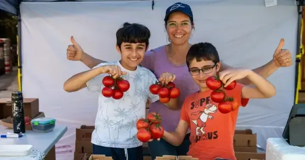 A family of tomato-growers and their goods at Farm Gate Market