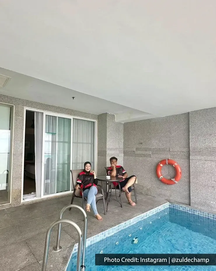 Guests sitting beside a private pool terrace at Lexis Suites Penang hotel room