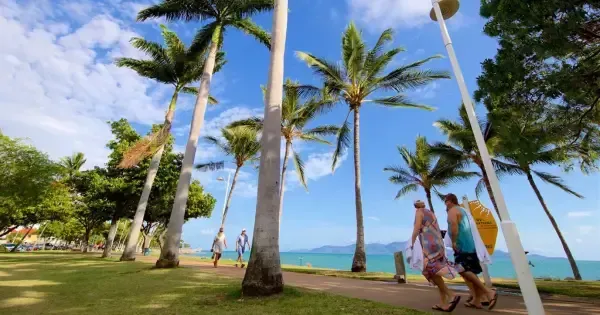 People walk The Strand Townsville on a beautiful blue sky day