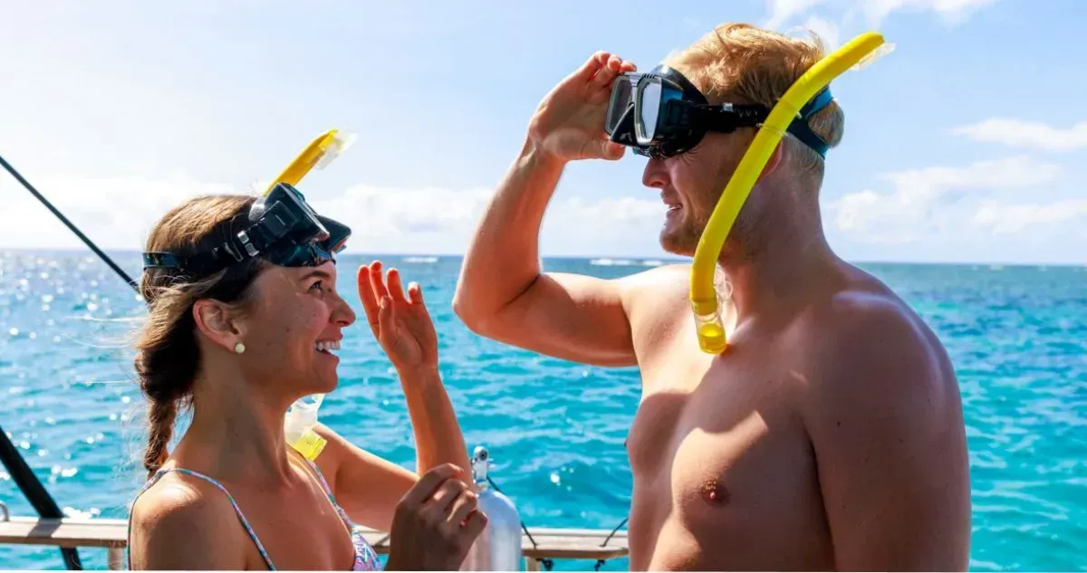 Two people on a boat, preparing to snorkel off Townsville