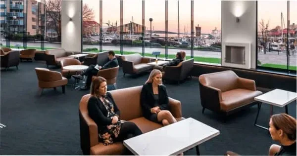A group of colleagues meeting in a naturally-lit room at the Hotel Grand Chancellor