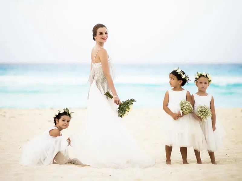Bride & 3 flower-girls on the beach near Grand Fiesta Americana