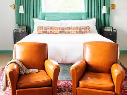 two leather chairs in front of bed at bradford house