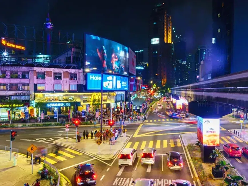 Busy streets in Bukit Bintang with colorful lights at night near Imperial Lexis KL Luxury Getaway - Imperial Lexis Kuala Lumpur