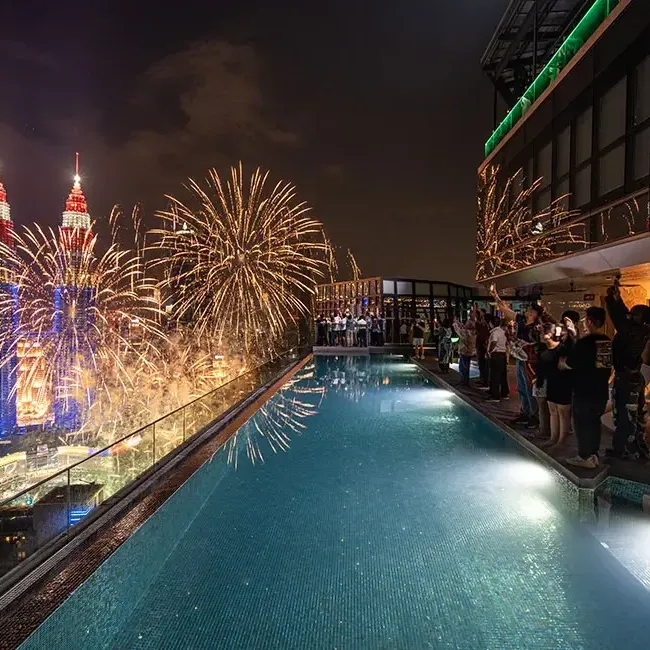 Guests enjoying a fireworks show from the Sky Infinity Pool at Imperial Lexis Kuala Lumpur - Lexis Hotels & Resorts