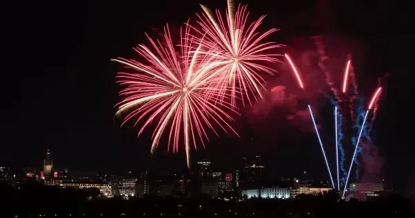 A fireworks display over a city at night