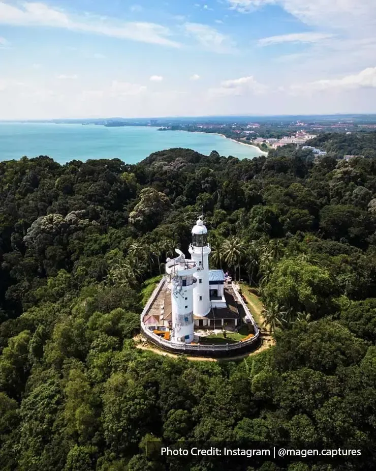 Bird's eye view of Cape Rachado Lighthouse surrounded by dense trees and greenery - Grand Lexis Port Dickson