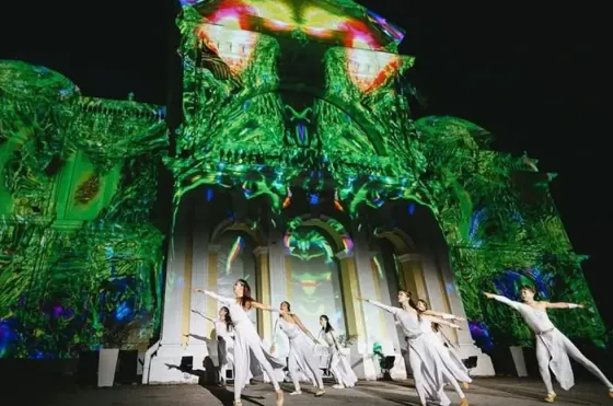Cultural dance performance with projection art on heritage building