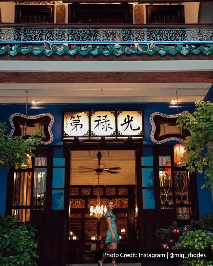 Tourist at Cheong Fatt Tze Mansion entrance in Penang.
