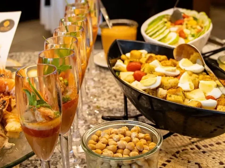 An array of seafood, salads, and drinks showcasing Azalaï Gastronomy Across Africa modern African hospitality on a plate.