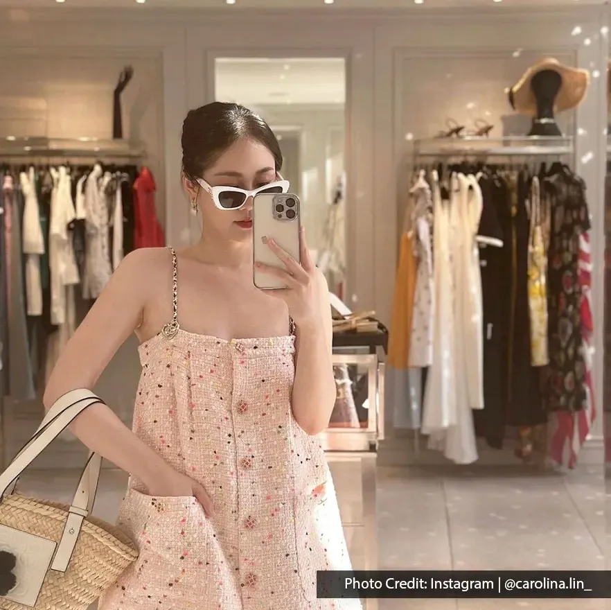 Shopper taking a mirror selfie inside a luxury fashion boutique at Suria KLCC