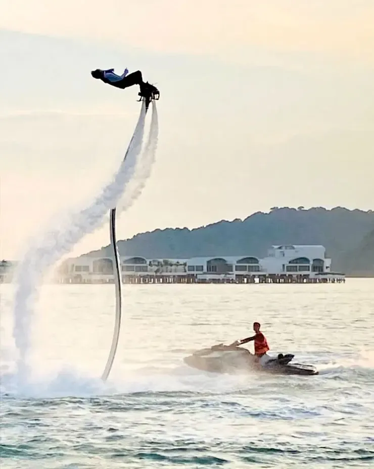 Flyboarder soaring above the water with high spray trail during water sports activity – Lexis Hibiscus Port Dickson