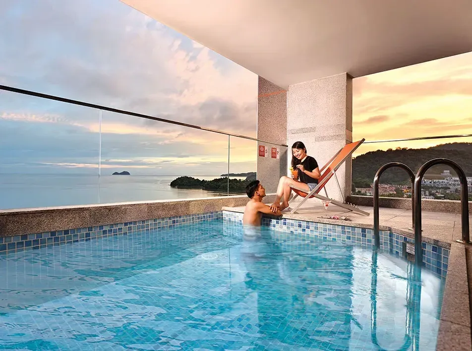 A couple relaxing in the private pool during their weekend trip at a hotel in Malaysia - Lexis MY