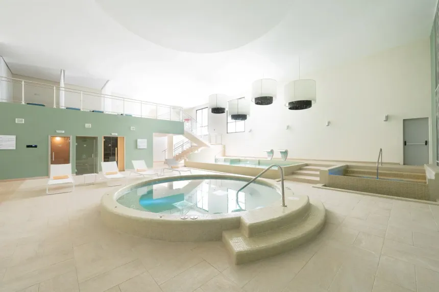 Beautiful indoor hydrotherapy pool and spa at Saint Martin Beach Resort & Spa, with lounge chairs and a relaxation area